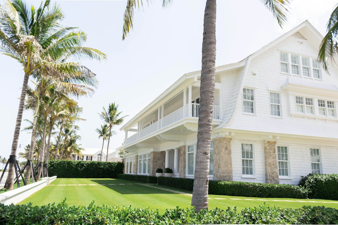 White wooden Florida home beside palm trees representing a homeowner facing foreclosure in 2026