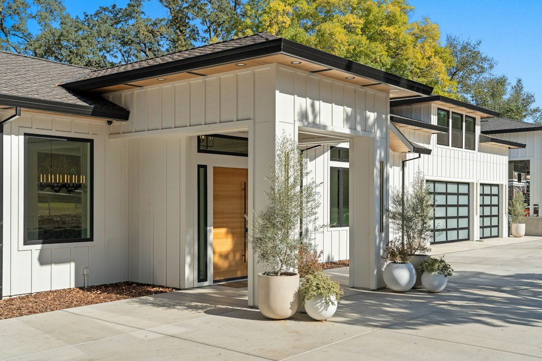 Suburban home with white siding and a wood front door representing a New Jersey homeowner facing foreclosure in 2026
